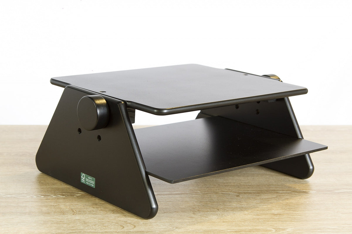 Black monitor stand side angle view on wooden desk