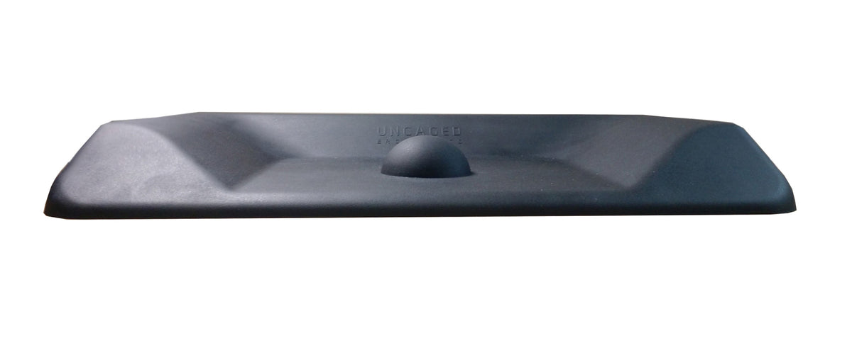 Black anti-fatigue mat top-down view showing contoured terrain and center massage ball