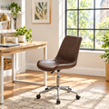 Brown faux leather armless office chair in a sunny home office