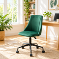 Forest green velvet office chair with black base in a sunny home office