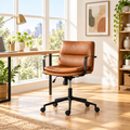 Cognac brown and black faux leather office chair in a sunny home office