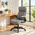 Gray faux leather executive office chair in a sunny home office