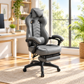 Gray racing-style gaming chair with footrest in a sunny home office
