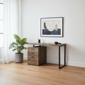 Brown and black computer desk with 3 drawers in a minimalist home office