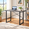 Gray and black computer desk in a bright home office