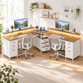 Two-person brown and white desk with two monitors and chairs in a bright shared workspace