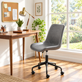 Gray faux leather mid-century office chair in a sunny home office