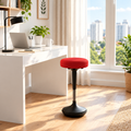 Red and black wobble balance stool in a sunny home office