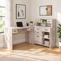 Taupe L-shaped computer desk with 8 drawers in a bright home office