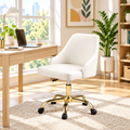 White faux leather office chair with gold base in a sunny home office