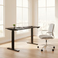 Black adjustable standing desk in a bright home office
