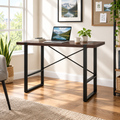 Dark brown and black computer desk in a bright home office