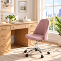 Dusty pink channel-tufted office chair with chrome base in a sunny home office