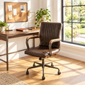 Distressed chocolate brown leather executive office chair in a sunny home office