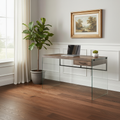 Brown and clear glass computer desk in a bright home office