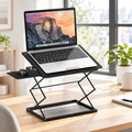 Black compact folding laptop desk with mousepad holding a laptop in a bright home office