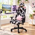 Black and white cow print gaming chair in a sunny home office
