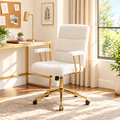 White boucle executive chair with gold frame in a sunny office