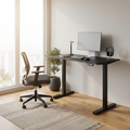 Black adjustable standing desk in a bright home office