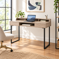 Taupe and black writing desk with 2 drawers in a bright home office